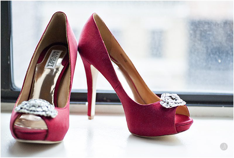 Red wedding shoes by a window