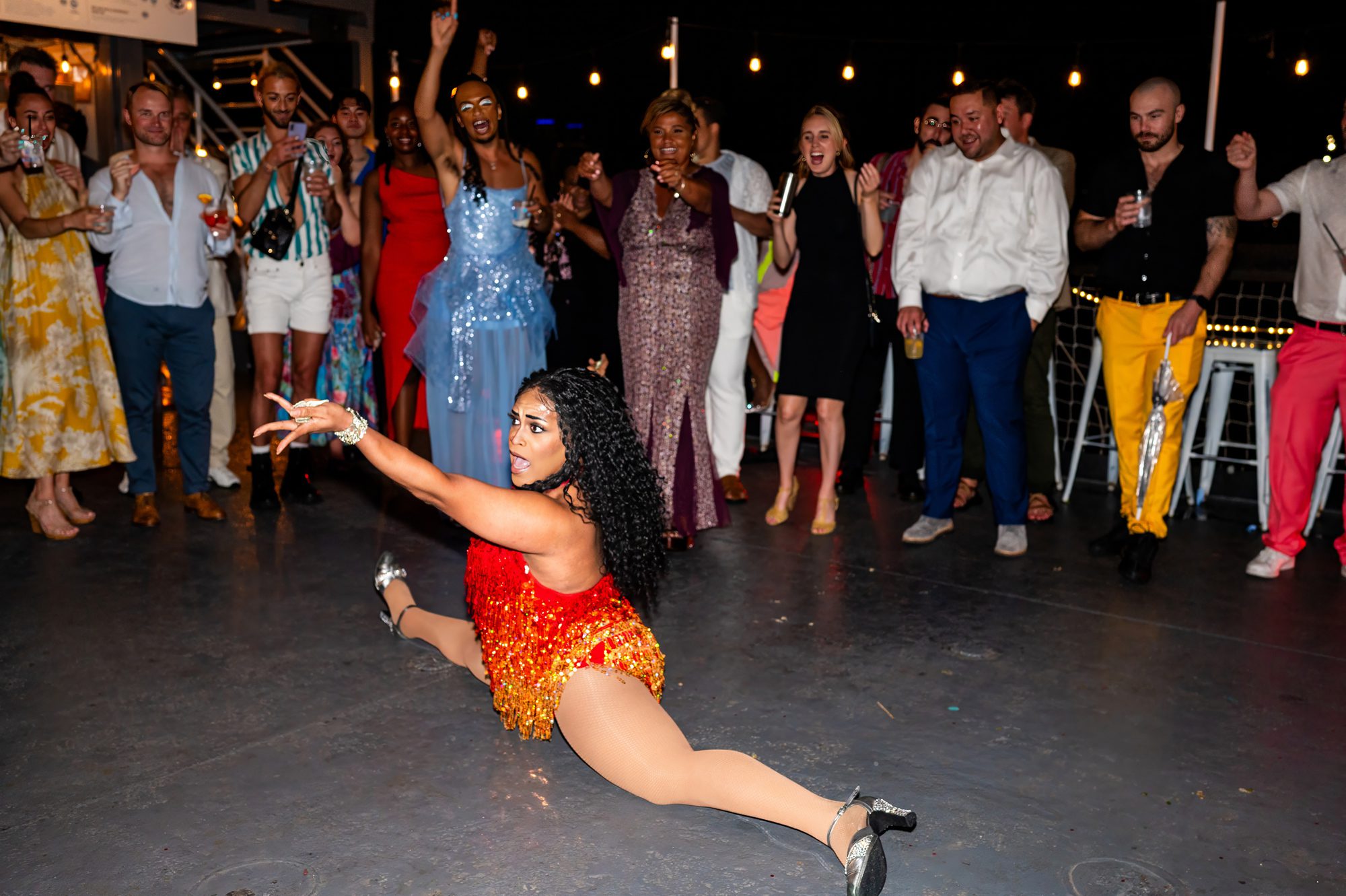 A drag queen doing the splits at a wedding in NYC 