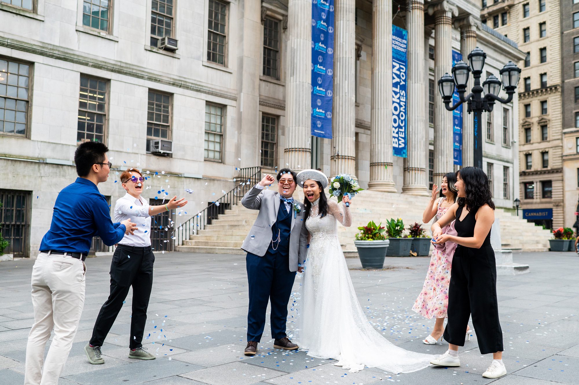 A couple cheering after getting married at Brooklyn City Hall