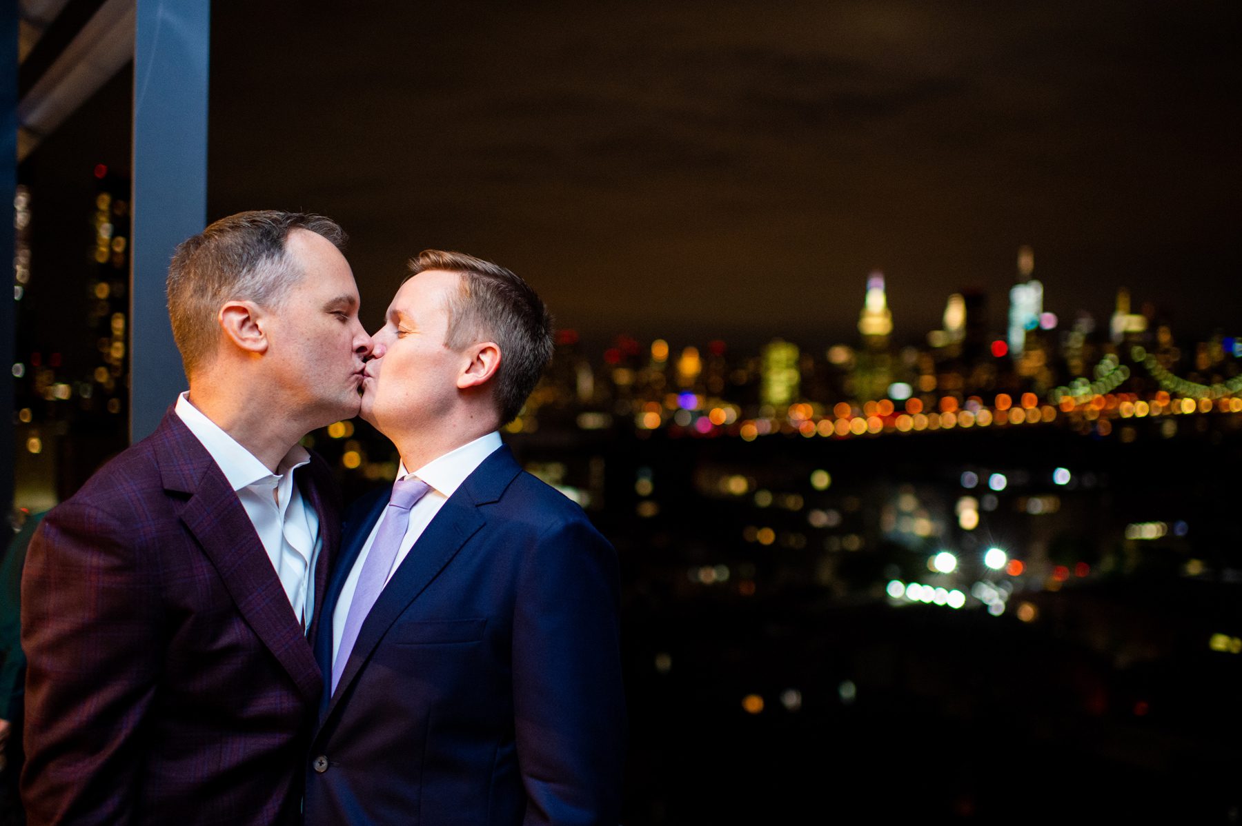 Grooms Kissing with NYC Skyline
