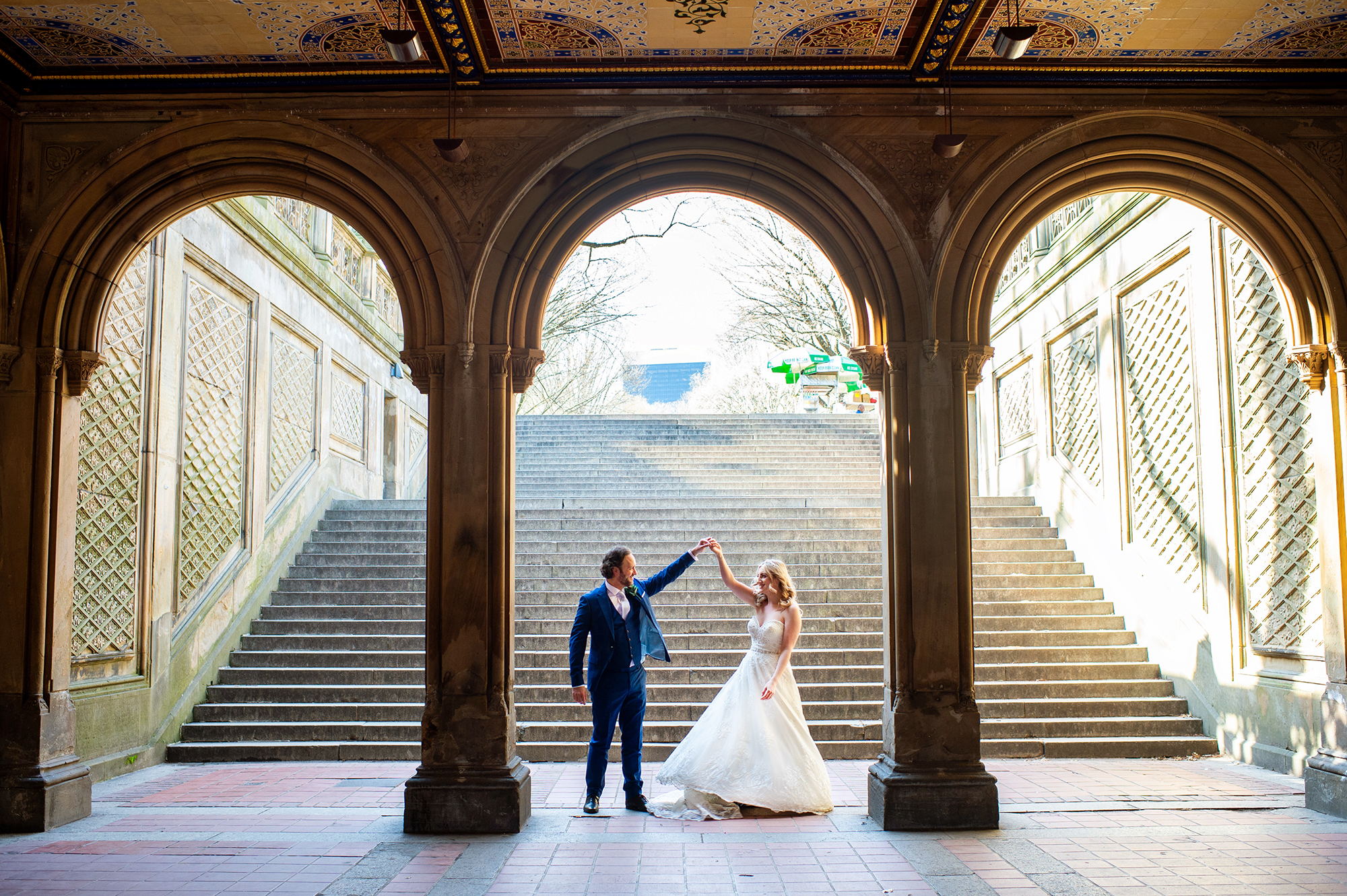 Bride and Groom dancing under the arches of Bethesda Terrace