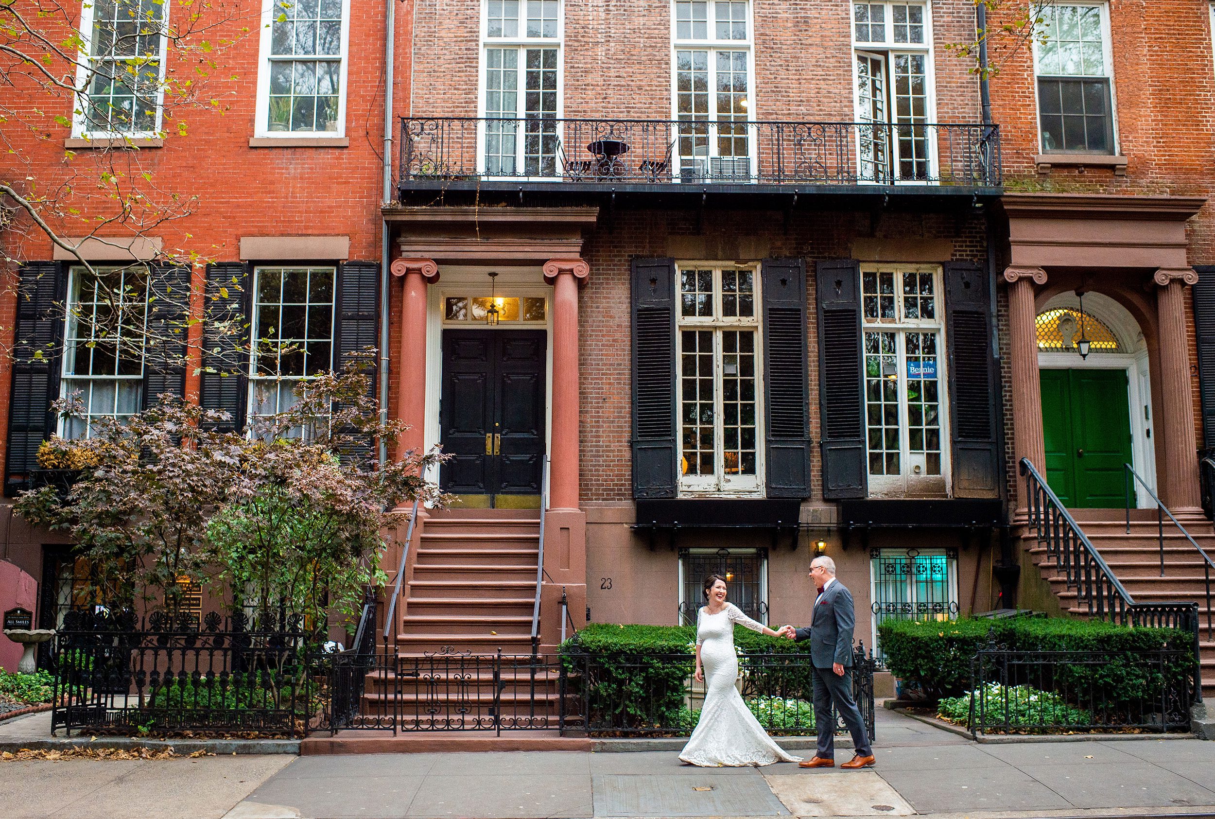 A Bride and Groom walking down the sidewalk in the West Village NYC