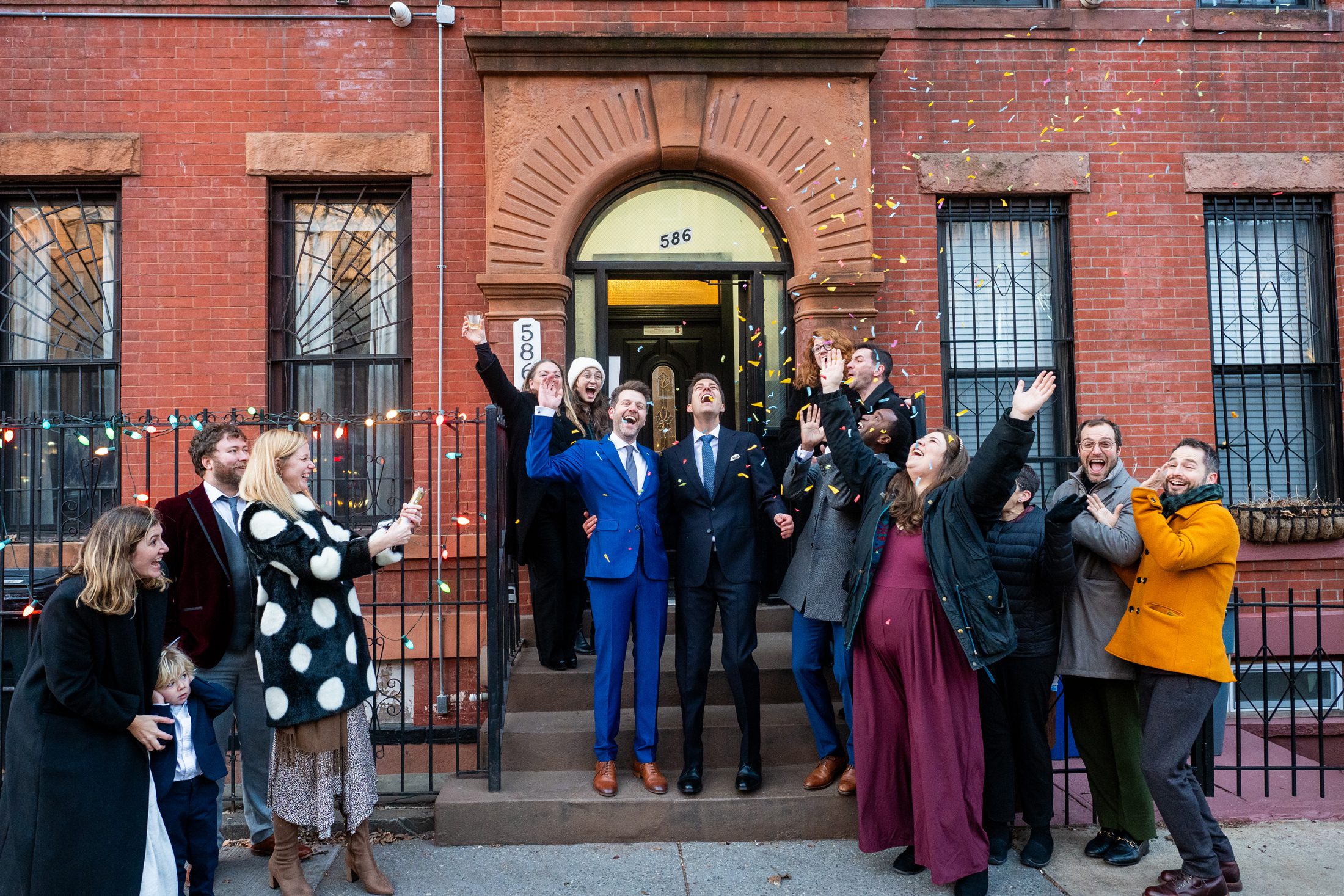 Couple cheering after eloping in a backyard in Brooklyn