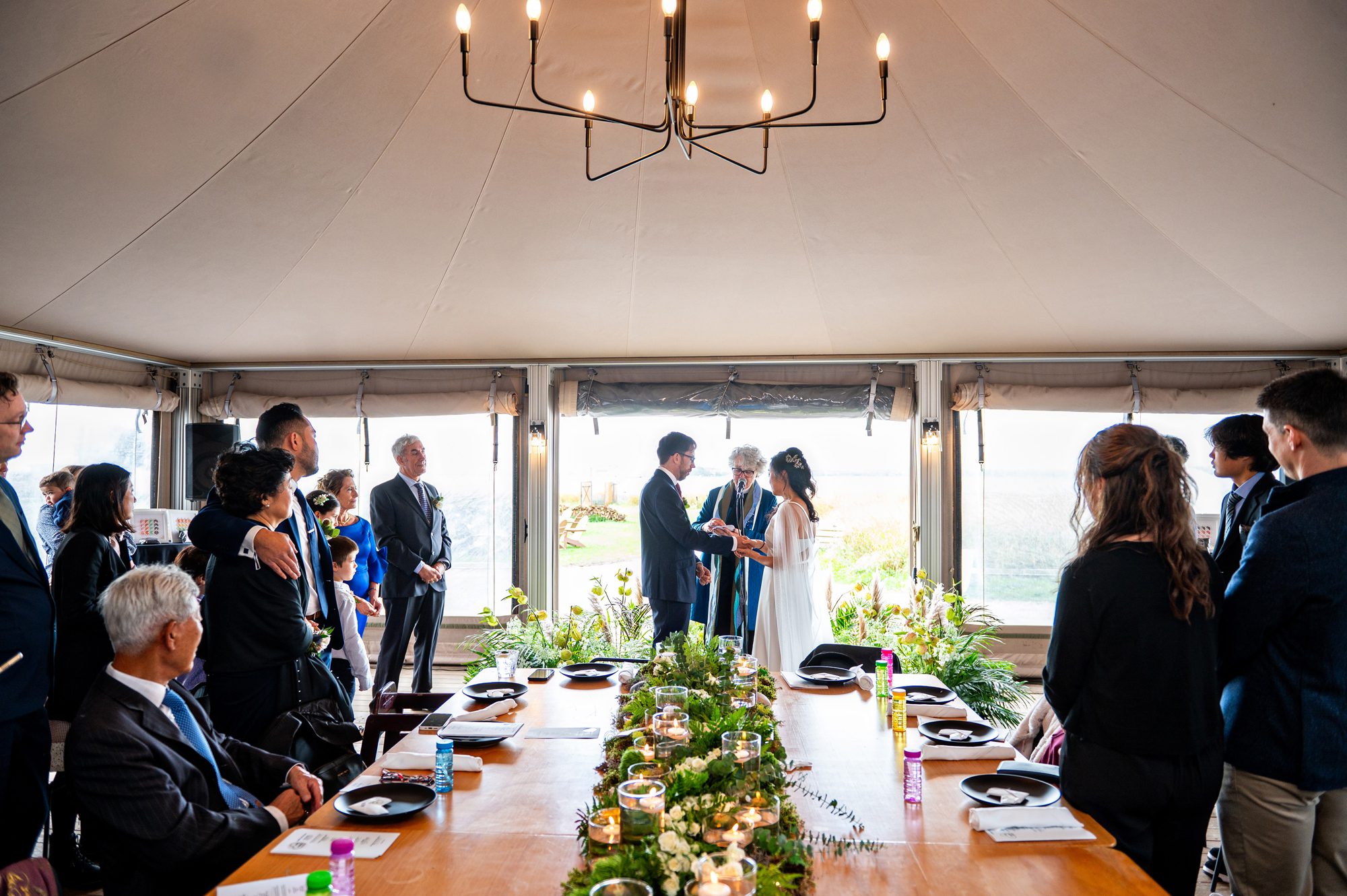Wedding ceremony in a tent at Governors Island Collective Retreats, a unique wedding venue in NYC