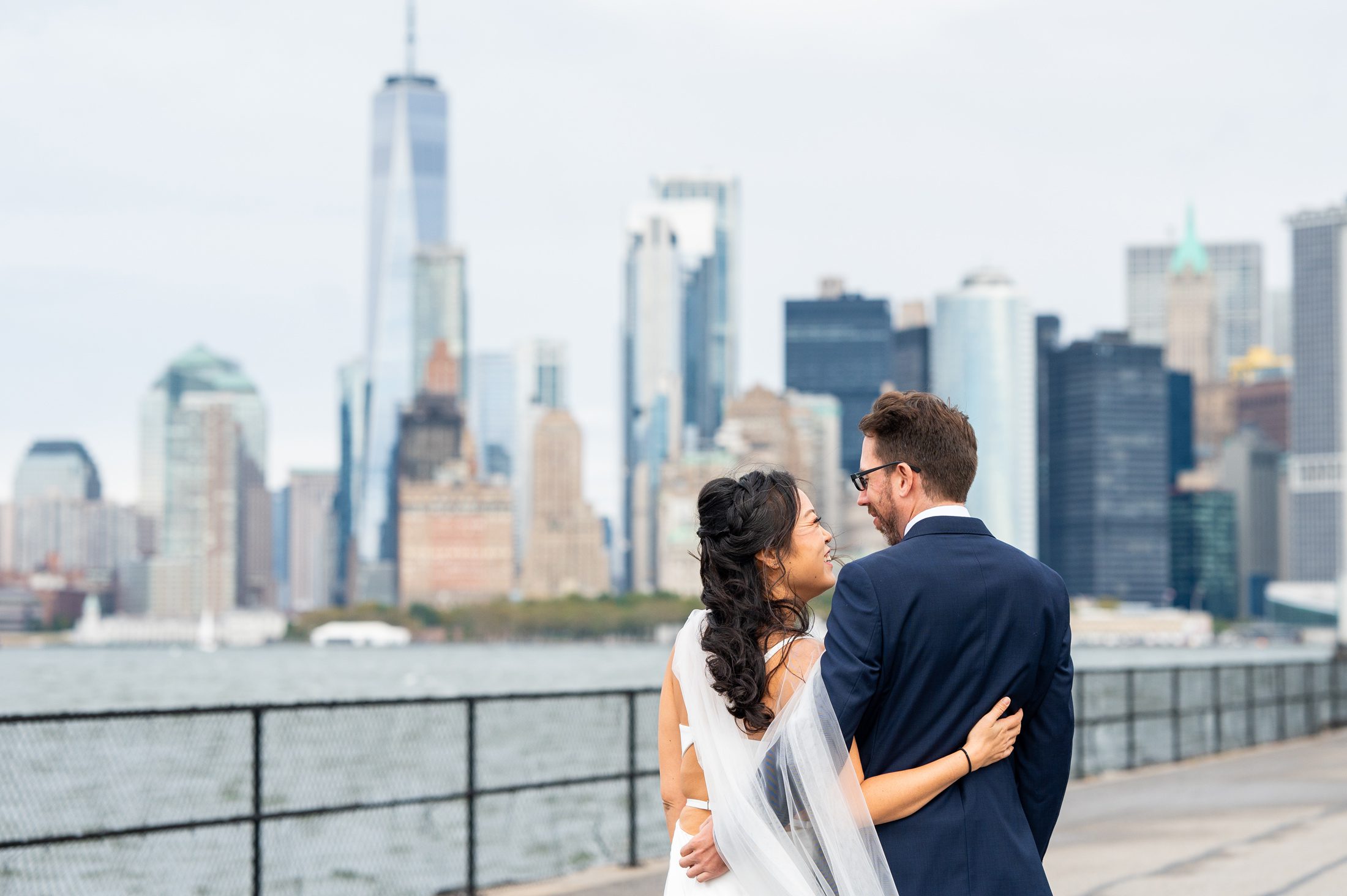 Couple facing each other with NYC skyline in the background