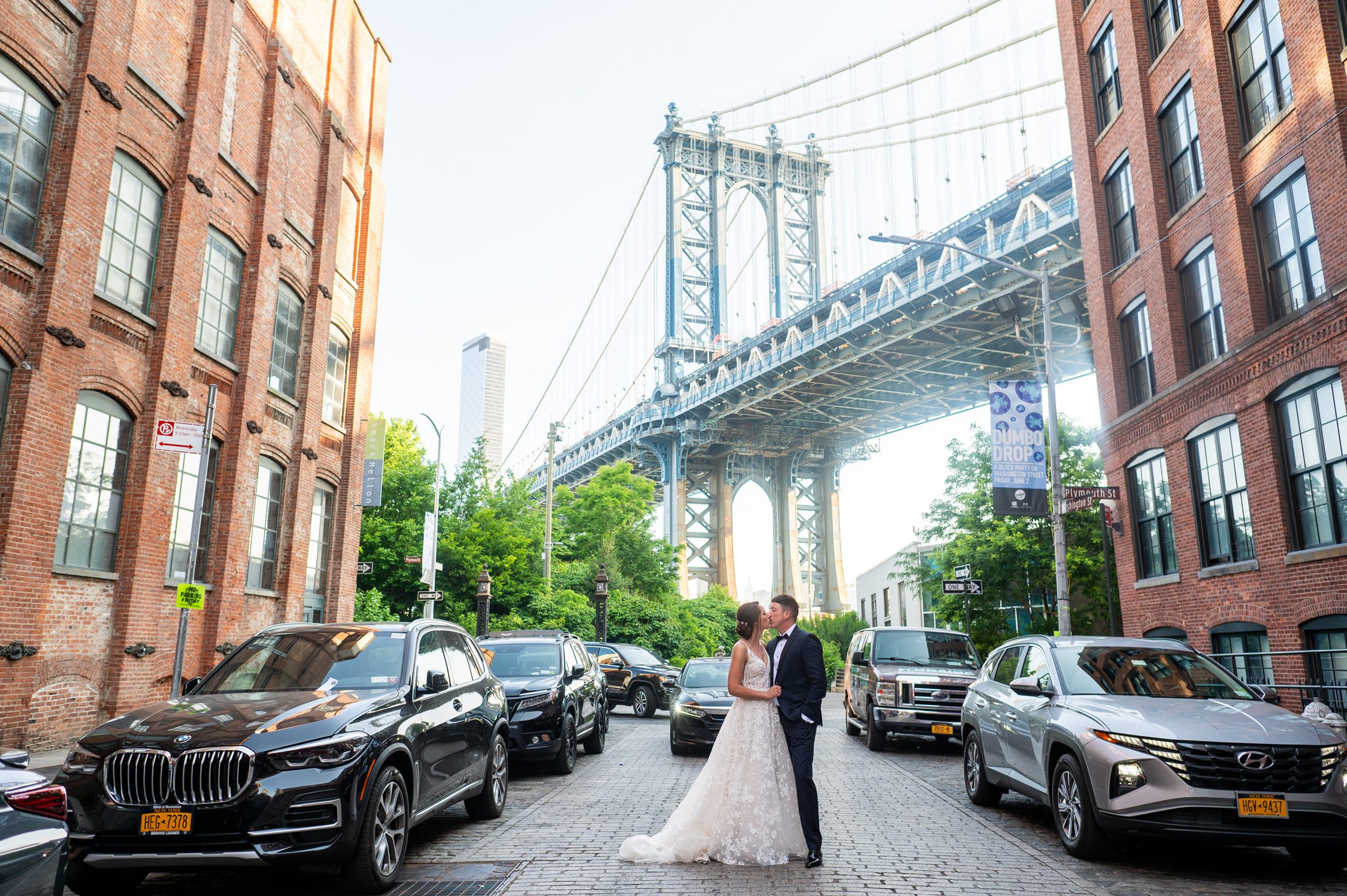 Couple kissing on Washington Street with Manhattan Bridge in the background. 