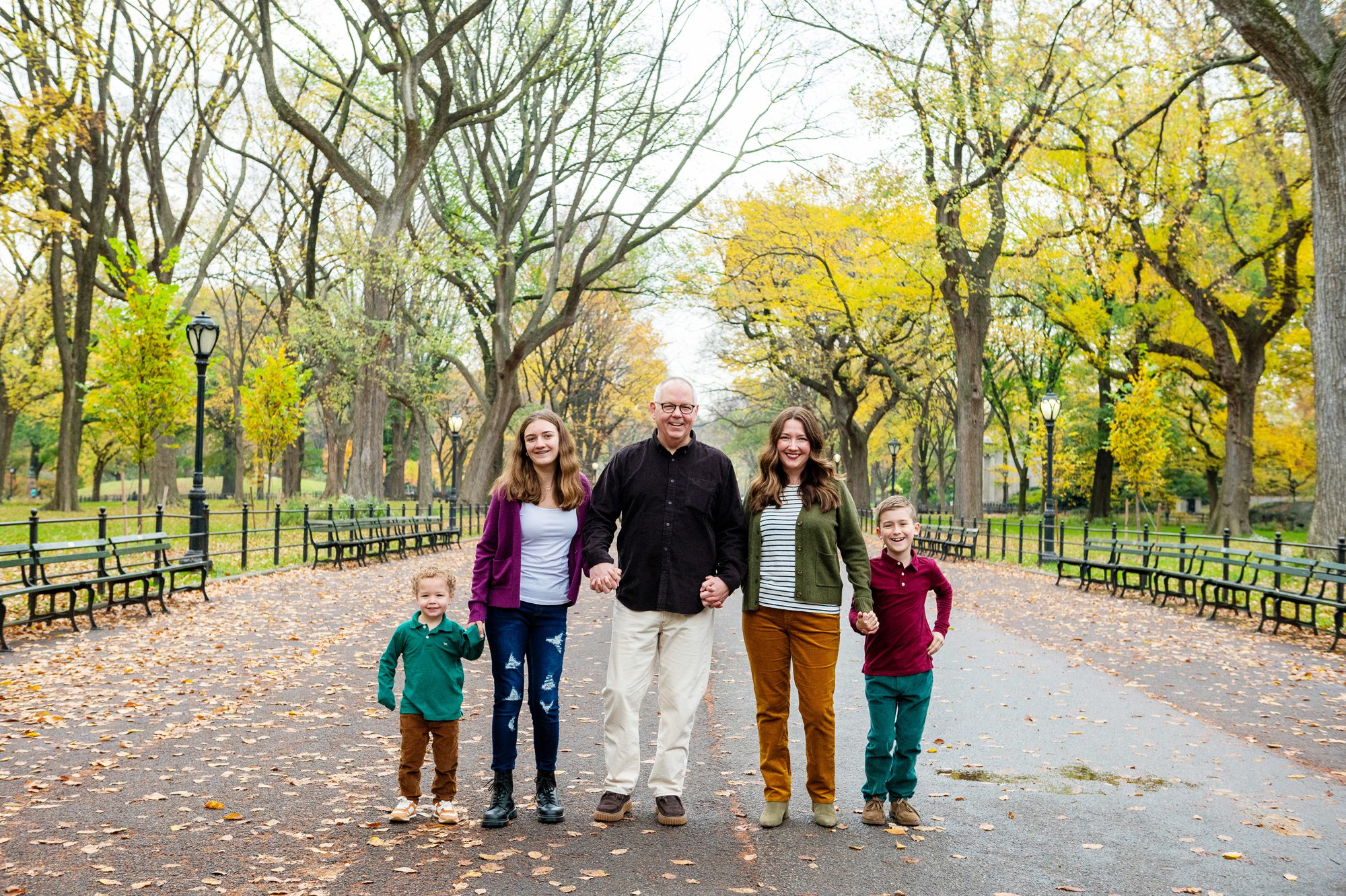 Family photography in Central Park in the fall. Family walking on literary walk in Central Park 