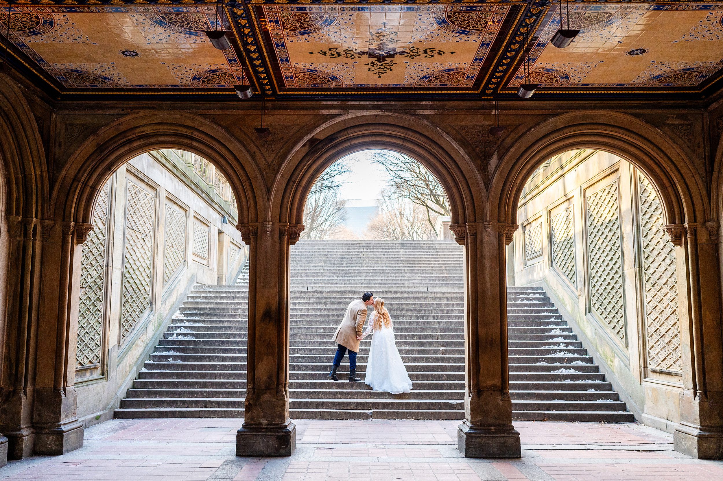 Couple kissing under Bethesda Terrace in Central Park 