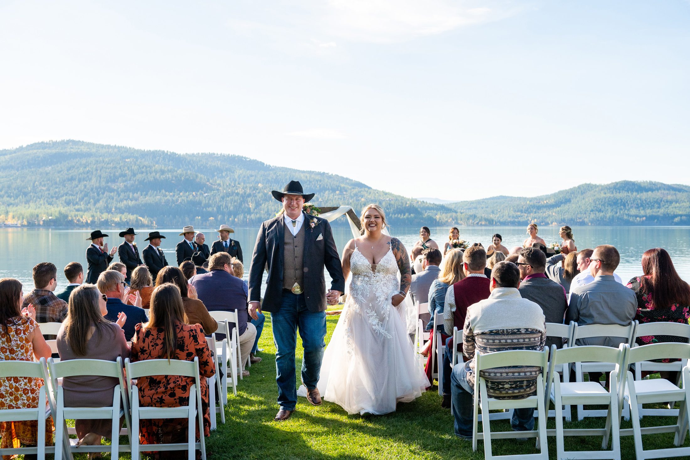 Couple exiting wedding ceremony at Lodge at Whitefish Lak e