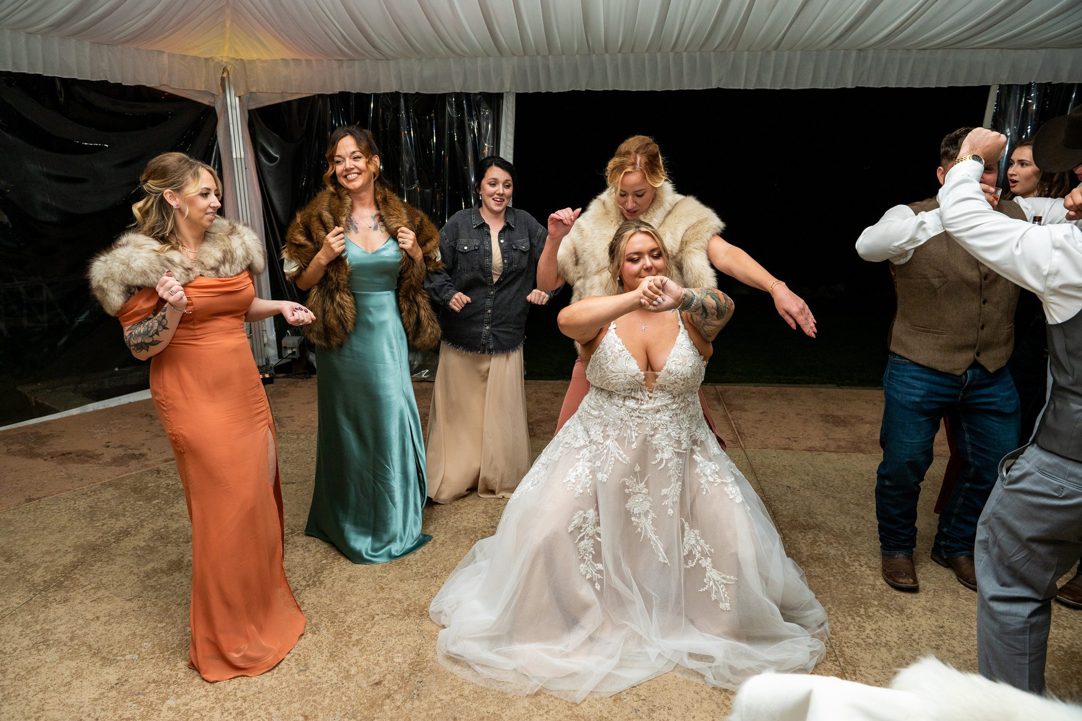 Bride dancing with friends at wedding reception at Lodge at Whitefish Lake 