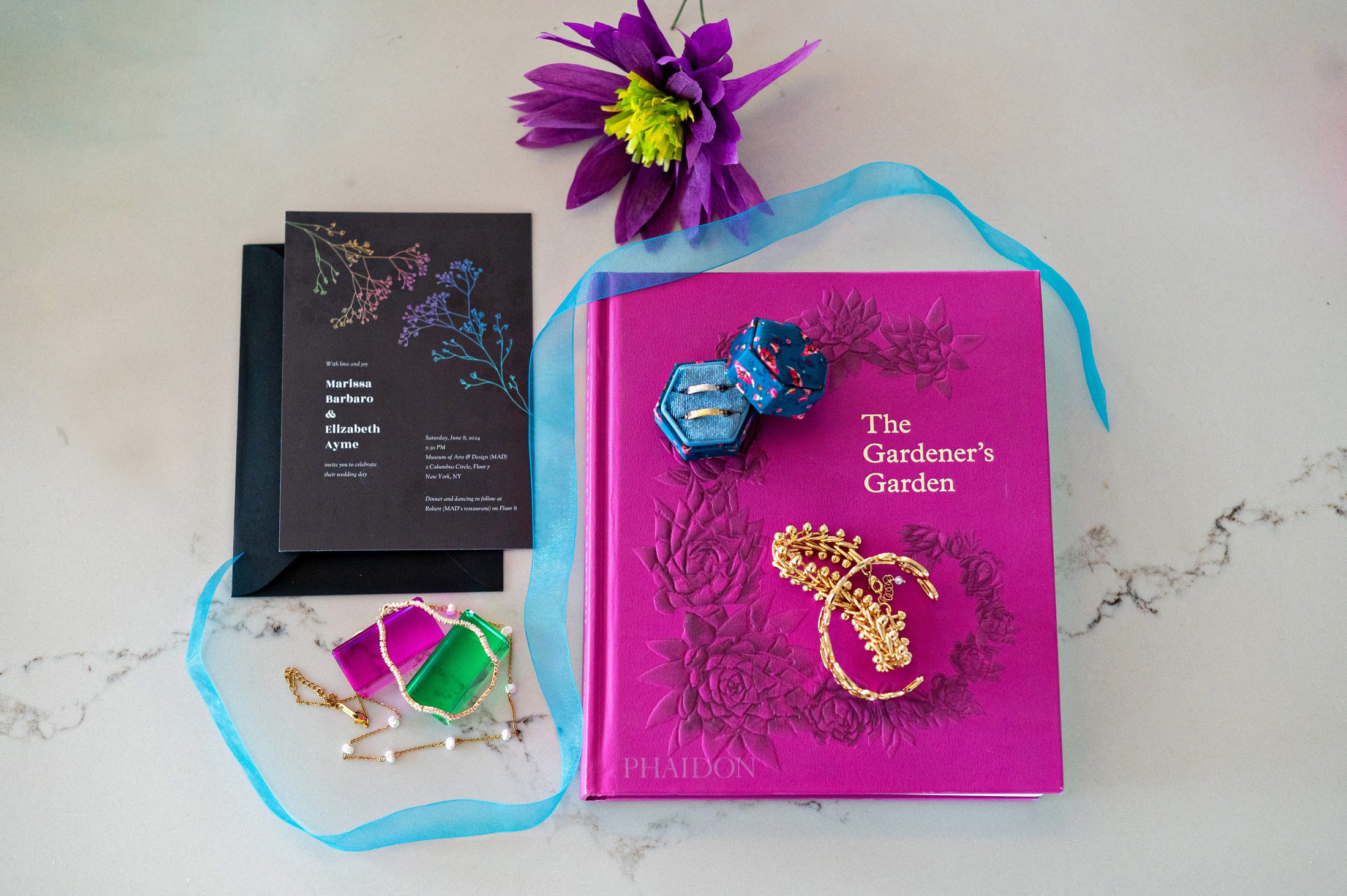 Wedding invitations, rings and flowers on a table