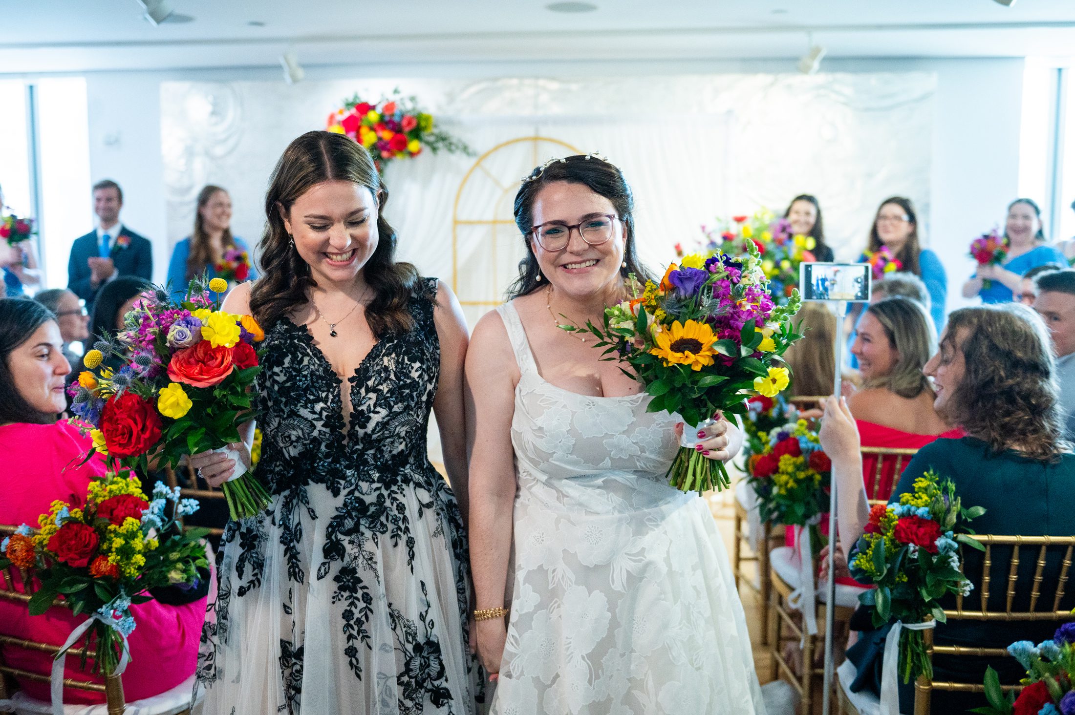 Two brides exiting wedding ceremony at Museum of Art and Design 