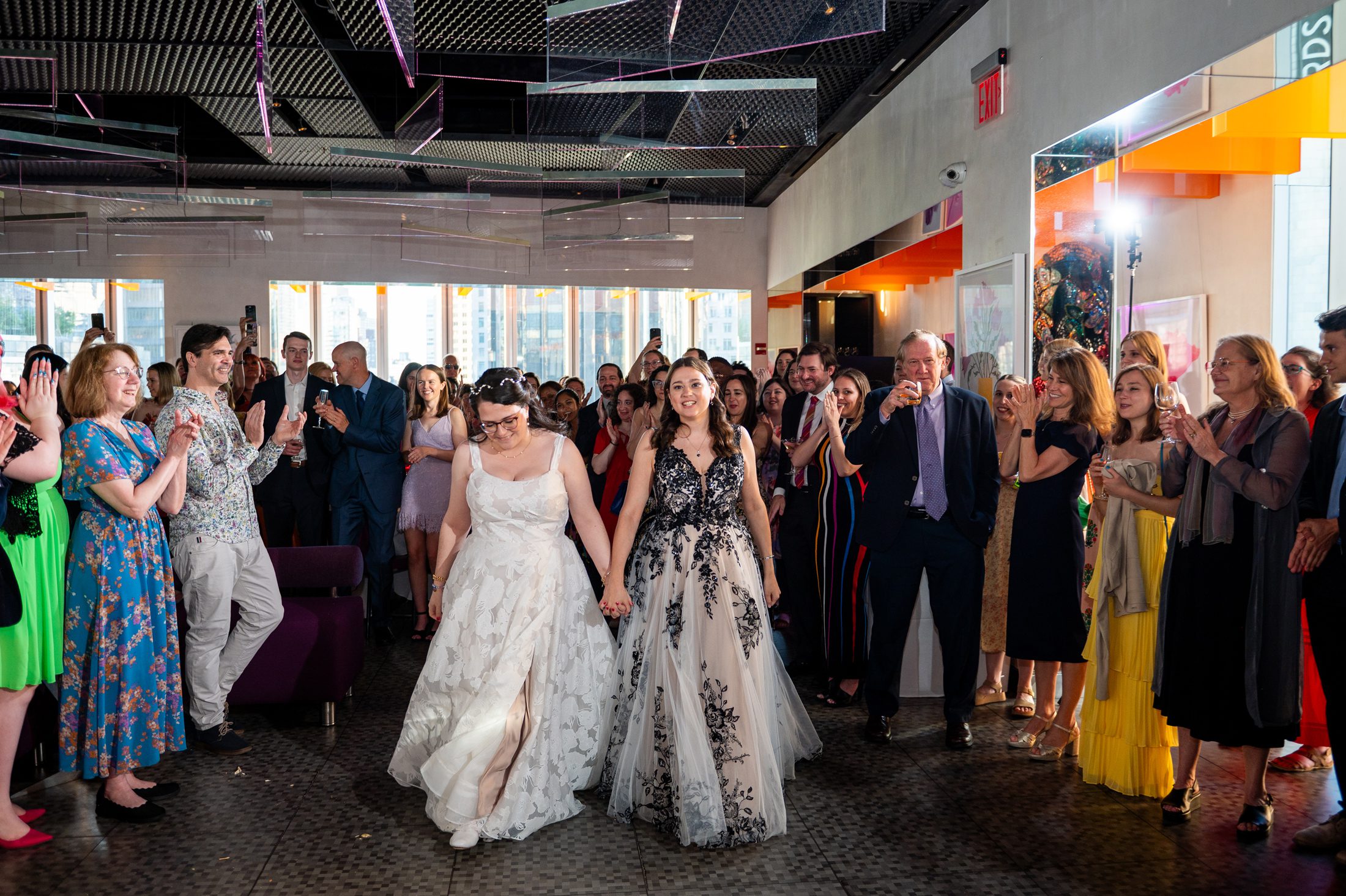 Two brides entering their wedding reception at the Robert at Museum of Art and Design in NYC