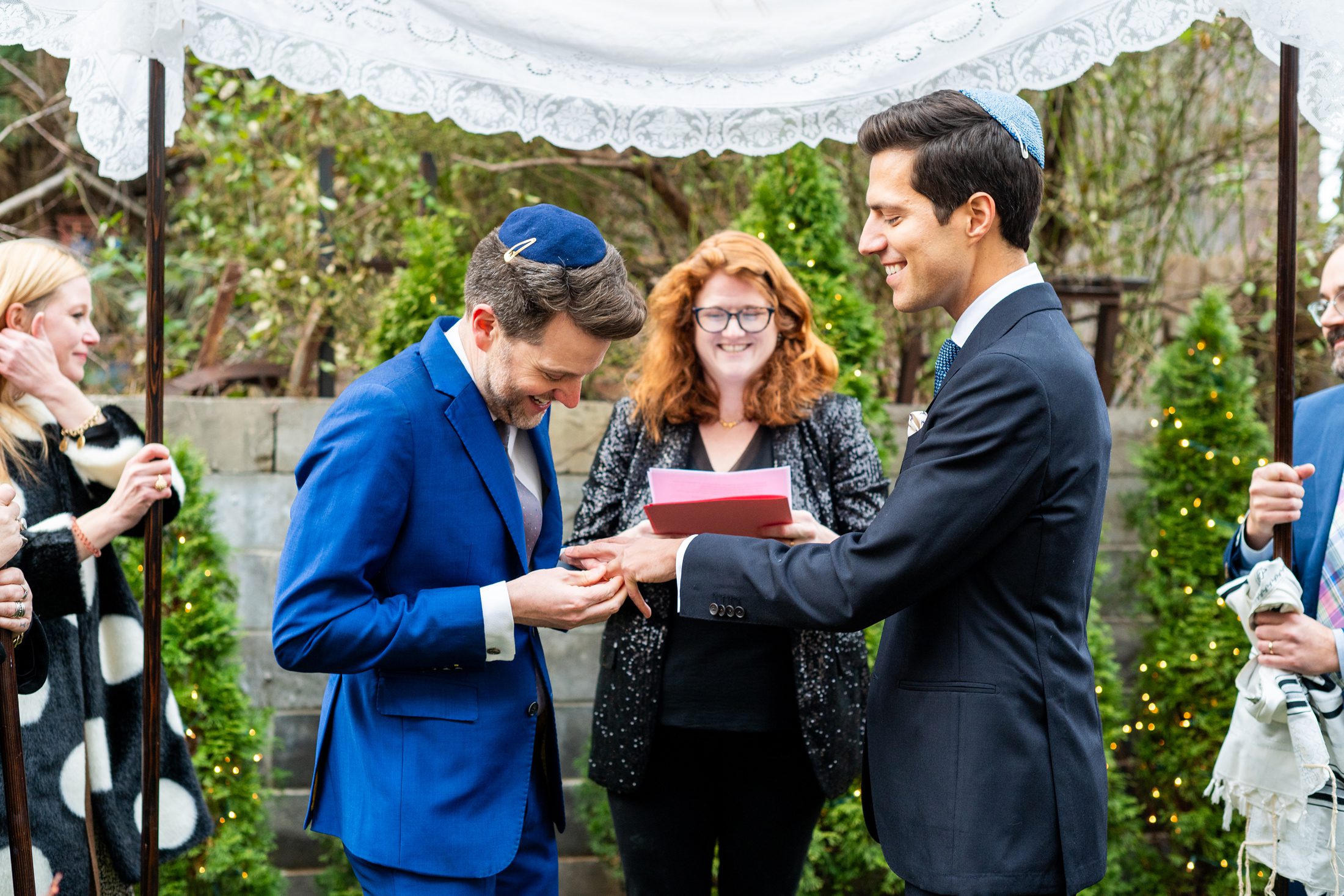 Grooms ring exchange in backyard wedding ceremony
