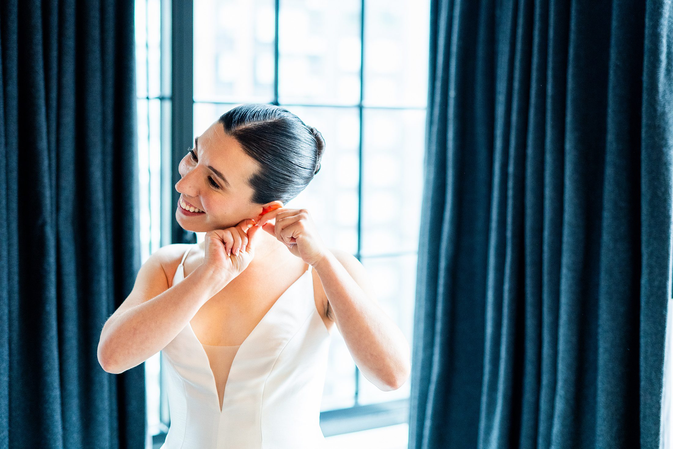 Bride putting in earrings at Ace Hotel Brooklyn 