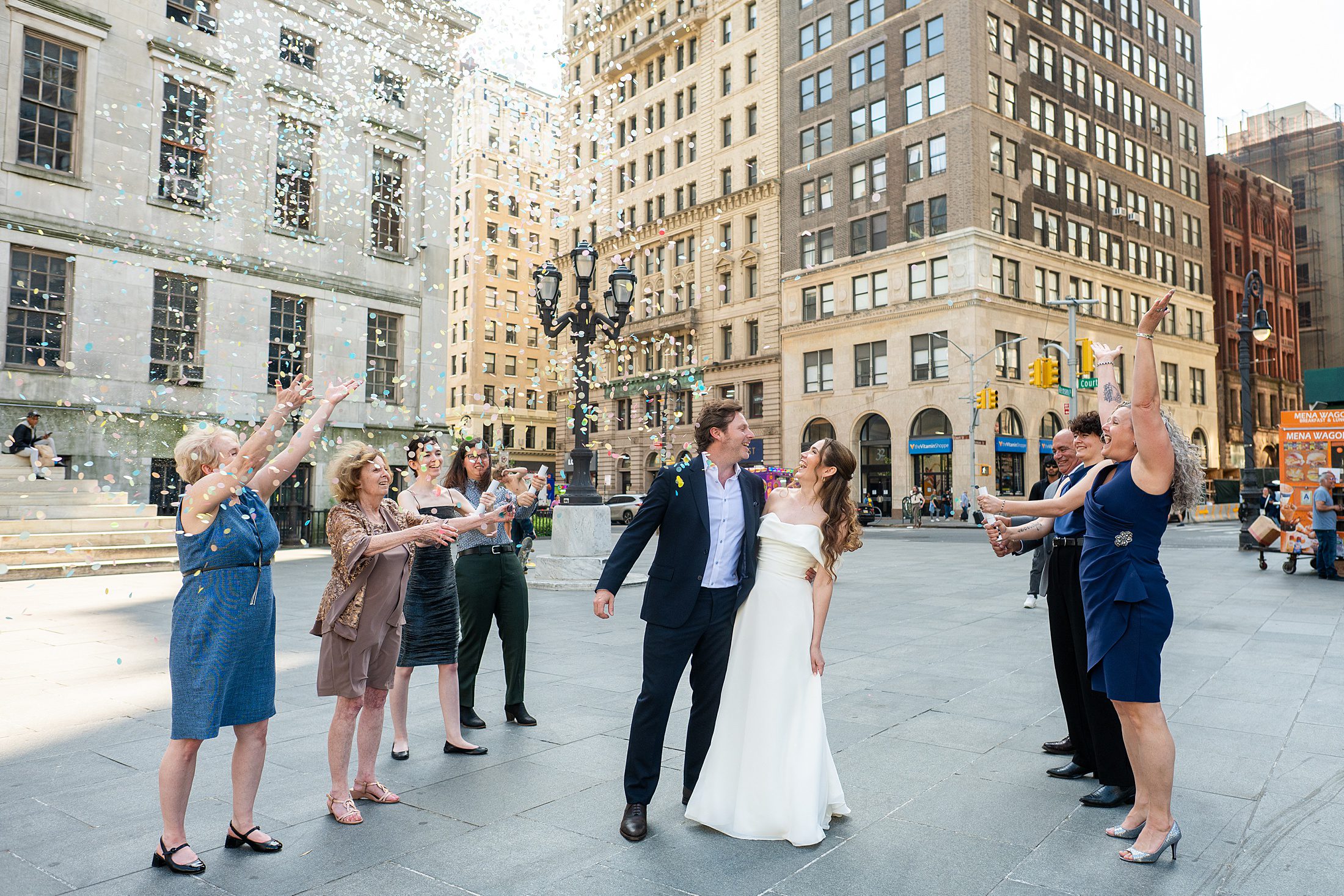 Couple celebrating in Cadman Plaza after their Brooklyn City Hall Wedding 