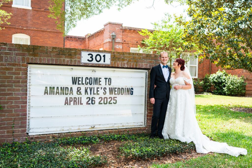 Couple at the sign in front of Venue 1902