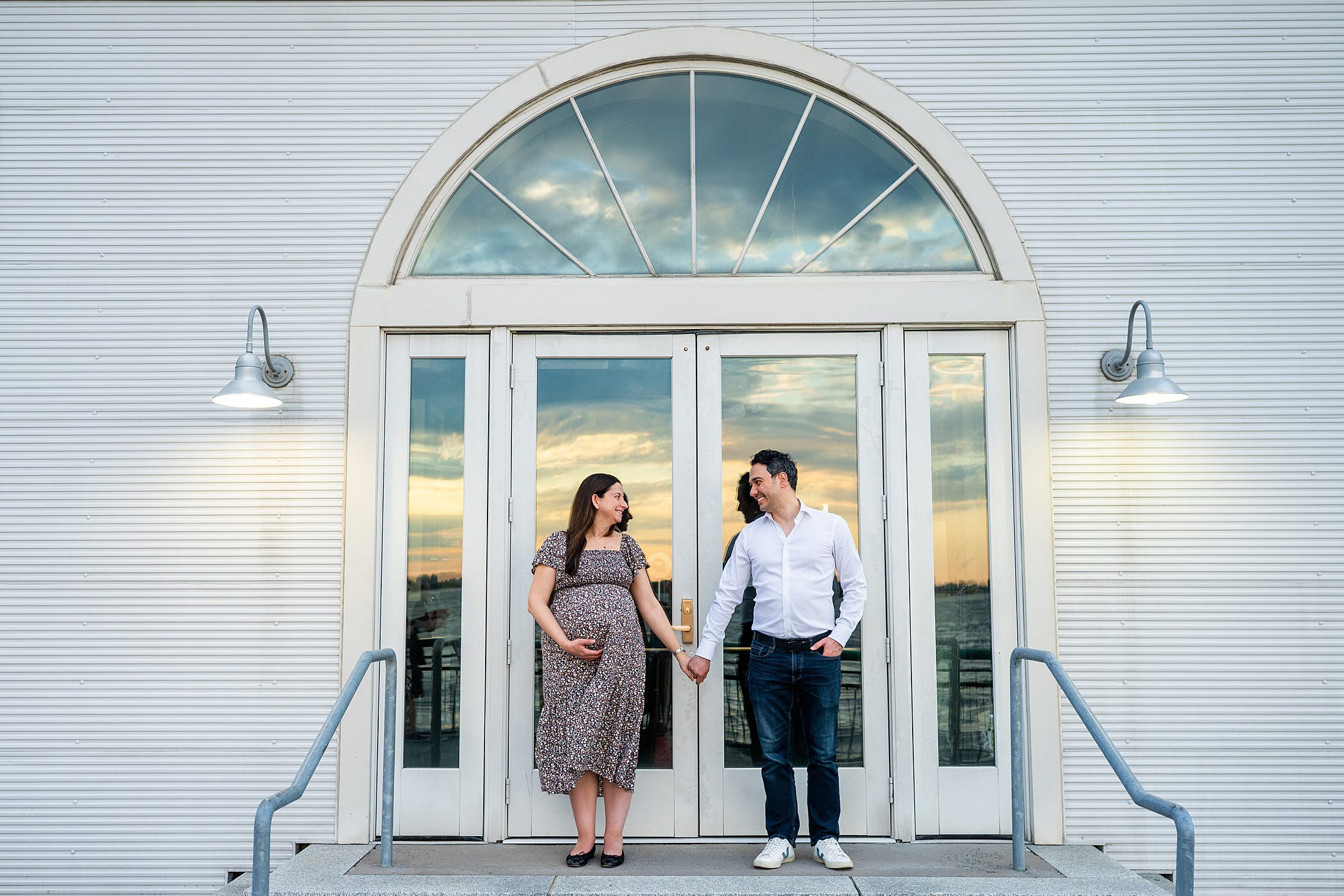 couple posing for maternity photos in battery park nyc